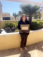 Rita Lyons, graphic arts technician at West Virginia Northern Community College, holds the Paragon Award she received from the National Council for Marketing and Public Relations for a billboard she designed on the college’s cyber security program. She received the award during the annual NCMPR conference held this year in Charleston, South Carolina.