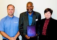 WVNCC Board of Governors Vice Chair Robert Contraguerro Jr. presents Board of Governors member Dr. Cummings with a plaque commemorating his time on the WVNCC Board along with Dr. Vicki L. Riley, president of WVNCC.