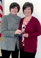 Kelly Paree, human resources representative/payroll at West Virginia Northern Community College, at right, is congratulated by WVNCC President Vicki L. Riley at a ceremony in Charleston where Paree was cited as Northern’s outstanding community college contributor for 2016-17.