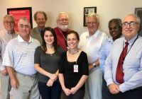 Members of the Weirton Rotary Club dedicate a plaque on the Weirton campus of West Virginia Northern Community College honoring the late Dan Wilson, a long-time member of the club. Front row, from left, are John Newbrough, Rotarian; Olga Trujque, Rotarian visitor from Mexico; Amy Howell, who works in the tutoring center at WVNCC; and Frank DeCaria, Rotarian and WVNCC faculty member. Back row, from left, are Bill Cattrell, Rotarian; George Kondik, Rotary president; Larry Tackett, campus dean, WVNCC; and Rotarians Steve Kladakis and Dr. S. Morisetty. Kondik is a member of the WVNCC Foundation Board of Trustees and Newbrough is a former member.