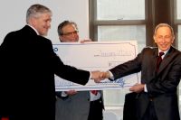 JP Morgan Chase & Co. officials display an oversized check representing $51,000 the firm has provided for scholarships to the Middle College High School Program at West Virginia Northern Community College. The check presentation occurred Tuesday during a media conference at the college. From left are Brad Blair, vice president and business banker at Chase in Wheeling; Stephen S. Bohach, Chase vice president, relationship manager II for Wheeling-Steubenville, and Dr. Martin J. Olshinsky, president of WVNCC.     