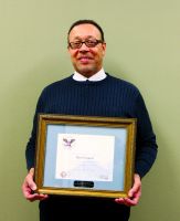 Darryl Clausell, coordinator, Continuing and Community Education at West Virginia Northern Community College, holds the Presidential Volunteer Service Award from President Barack Obama he received for being designated a “Drum Major for Service.” Clausell was nominated for the honors by Youth Services System Inc. of Wheeling.