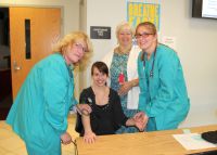 Students in the Medical Assistant program at West Virginia Northern Community College take a blood pressure reading and pulse as part of activities during Medical Assistants Recognition Week. From left, student Carol Helmick takes the blood pressure of Natalie Staffileno while student Lauren Seckman takes her pulse. In back is Michele Watson, director of the WVNCC program.